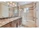 Elegant bathroom features a marble countertop, shower over tub, and decorative tile accents at 9909 Moon Valley Pl, Las Vegas, NV 89134