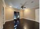 Bedroom showcasing dark hardwood flooring, a ceiling fan, and French doors to the outdoors at 9909 Moon Valley Pl, Las Vegas, NV 89134