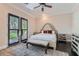Bedroom with dark wood floors, shuttered french doors to yard, and neutral tones at 9909 Moon Valley Pl, Las Vegas, NV 89134
