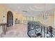 Elegant foyer featuring a wrought iron staircase and ornate chandelier with marble flooring at 9909 Moon Valley Pl, Las Vegas, NV 89134