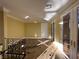 Hallway featuring decorative black iron railing, arched doors, and travertine flooring at 9909 Moon Valley Pl, Las Vegas, NV 89134