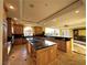 Spacious kitchen with large island, wooden cabinets, granite counters, and stainless steel appliances at 9909 Moon Valley Pl, Las Vegas, NV 89134