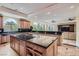 Spacious kitchen with center island, granite countertops, modern appliances, and beautiful cabinets at 9909 Moon Valley Pl, Las Vegas, NV 89134
