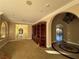 Open floor plan living room featuring an archway, mosaic floors, and a built-in bookshelf at 9909 Moon Valley Pl, Las Vegas, NV 89134