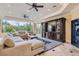 Cozy living room featuring entertainment center, comfortable sofa, and view of the pool at 9909 Moon Valley Pl, Las Vegas, NV 89134
