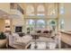 Bright, open living room with large windows and luxurious furnishings at 9909 Moon Valley Pl, Las Vegas, NV 89134