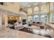 Open-concept living room with tall windows, a fireplace, and a wrought iron balcony at 9909 Moon Valley Pl, Las Vegas, NV 89134