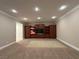 Media room showcasing built-in wood cabinets, recessed lighting, and a large beige carpet at 9909 Moon Valley Pl, Las Vegas, NV 89134
