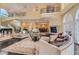 Expansive living area with fireplace, staircase, and open view to dining room at 9909 Moon Valley Pl, Las Vegas, NV 89134