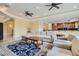 Comfortable seating area in an open concept living space with stylish decor and travertine flooring at 9909 Moon Valley Pl, Las Vegas, NV 89134