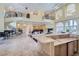 Open-concept living space with marble floors, high ceilings, and a wet bar at 9909 Moon Valley Pl, Las Vegas, NV 89134