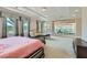 Spacious main bedroom with tray ceiling, a sitting area, and large windows at 9909 Moon Valley Pl, Las Vegas, NV 89134