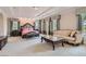 Spacious main bedroom with tray ceiling, a sitting area, and large windows at 9909 Moon Valley Pl, Las Vegas, NV 89134