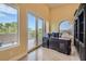 Bright office with large windows and an adjacent balcony offering scenic views and custom built-ins at 9909 Moon Valley Pl, Las Vegas, NV 89134
