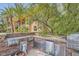 Built-in outdoor kitchen with stainless steel appliances and a stone countertop, perfect for entertaining at 9909 Moon Valley Pl, Las Vegas, NV 89134