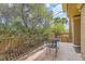 View of the outdoor patio with greenery, outdoor seating and railings at 9909 Moon Valley Pl, Las Vegas, NV 89134