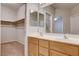 Bathroom featuring double sinks, large mirror, and a walk-in closet at 10026 Mystic Dance St, Las Vegas, NV 89183