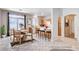 Bright kitchen and breakfast nook area with tile floors, a dining table, and breakfast bar seating, all bathed in natural light at 10026 Mystic Dance St, Las Vegas, NV 89183