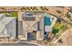 Aerial view of a home featuring a pool, spa, outdoor kitchen, and solar panels at 10096 Amethyst Hills St, Las Vegas, NV 89148