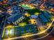 Night aerial showcasing the community clubhouse featuring pool, tennis, bocce ball, and ample parking at 10096 Amethyst Hills St, Las Vegas, NV 89148