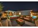 Beautiful backyard featuring a pool, waterfall, fire pit, and comfortable lounge seating at 10096 Amethyst Hills St, Las Vegas, NV 89148
