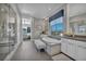Bright bathroom with a soaking tub, double vanity, white cabinetry, and a separate glass enclosed shower at 10096 Amethyst Hills St, Las Vegas, NV 89148