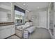 Bright bathroom with a soaking tub, double vanity, white cabinetry, and a separate glass enclosed shower at 10096 Amethyst Hills St, Las Vegas, NV 89148
