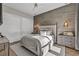 Modern bedroom with neutral tones, stylish lighting fixtures, wood floors, and a plush bed for a cozy retreat at 10096 Amethyst Hills St, Las Vegas, NV 89148