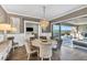 Dining room features a crystal chandelier, modern decor, and sliding door access to an outdoor pool area at 10096 Amethyst Hills St, Las Vegas, NV 89148
