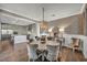 Dining room with elegant chandelier open to modern kitchen at 10096 Amethyst Hills St, Las Vegas, NV 89148