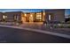 Beautiful modern home featuring professional landscaping and a brick paver driveway at sunset at 10096 Amethyst Hills St, Las Vegas, NV 89148