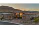 Charming home displaying elegant design, a neatly paved driveway, and scenic mountain views at 10096 Amethyst Hills St, Las Vegas, NV 89148