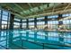 Indoor swimming pool with floor to ceiling windows, lane markers, and ample seating at 10096 Amethyst Hills St, Las Vegas, NV 89148