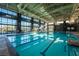 Indoor swimming pool with floor to ceiling windows, lane markers, and ample seating at 10096 Amethyst Hills St, Las Vegas, NV 89148