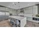 Bright kitchen with stainless steel appliances, large island, and breakfast bar seating at 10096 Amethyst Hills St, Las Vegas, NV 89148