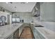 Spacious kitchen with stainless steel appliances, waterfall island, and wood-style floors at 10096 Amethyst Hills St, Las Vegas, NV 89148