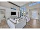 Bright living room featuring modern furniture, hardwood floors, high ceilings and natural light at 10096 Amethyst Hills St, Las Vegas, NV 89148