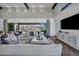 Bright living room with modern furnishings, sliding glass doors leading to a patio, and scenic views at 10096 Amethyst Hills St, Las Vegas, NV 89148