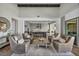 Open concept living area with hardwood floors, high ceilings, modern furniture, and abundant natural light at 10096 Amethyst Hills St, Las Vegas, NV 89148