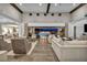 A spacious living room with high ceilings, wood floors, and an expansive outdoor view at 10096 Amethyst Hills St, Las Vegas, NV 89148