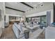 Open-concept living room with a view into the kitchen and large sliding doors at 10096 Amethyst Hills St, Las Vegas, NV 89148