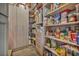 Walk-in pantry with custom shelving and storage for organized food items at 10096 Amethyst Hills St, Las Vegas, NV 89148