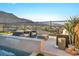 Stylish outdoor patio with mountain views, poolside seating area and integrated waterfall at 10096 Amethyst Hills St, Las Vegas, NV 89148
