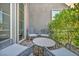 Cozy patio featuring an outdoor table with four chairs, adjacent to lush greenery at 10096 Amethyst Hills St, Las Vegas, NV 89148