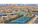 Aerial view of community pickleball courts with a covered picnic area and neighborhood homes in the background at 10096 Amethyst Hills St, Las Vegas, NV 89148
