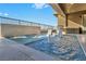 Modern pool with water feature and swim-up seating, perfect for outdoor relaxation and entertaining at 10096 Amethyst Hills St, Las Vegas, NV 89148