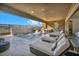 A beautiful outdoor covered pool and spa area with lounge chairs, an outdoor kitchen, and mountain views at 10096 Amethyst Hills St, Las Vegas, NV 89148