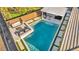 An aerial view of a modern backyard pool with a waterfall feature and outdoor seating area at 10096 Amethyst Hills St, Las Vegas, NV 89148