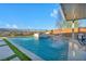 A modern pool with waterfall feature and artificial turf, seamlessly blending luxury and comfort at 10096 Amethyst Hills St, Las Vegas, NV 89148