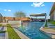 Inviting backyard pool with a waterfall feature and lush green turf, perfect for relaxation at 10096 Amethyst Hills St, Las Vegas, NV 89148